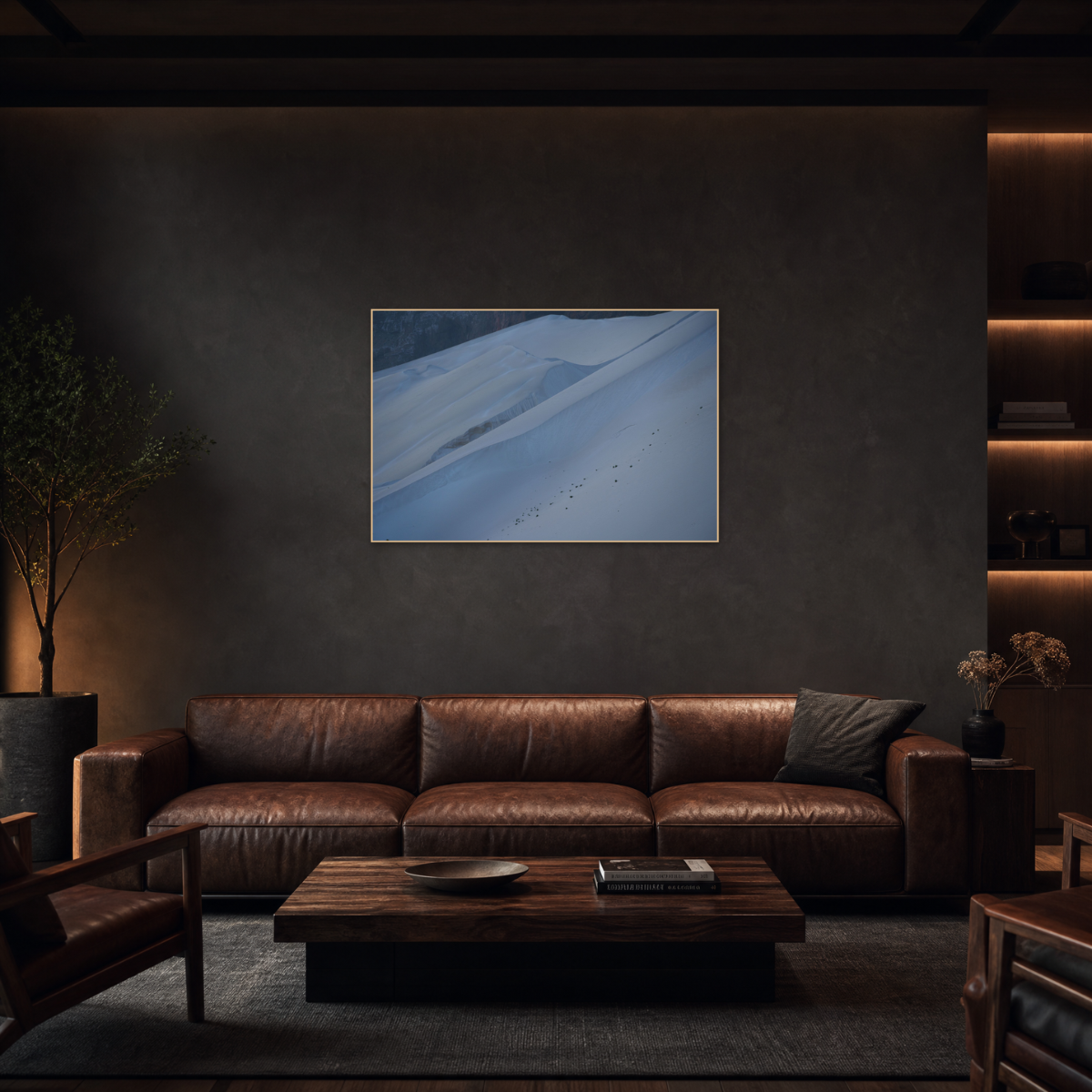Gito.Art - Exclusive Art Print - Photography by Delyan Markov
A framed landscape art print depicting snowy blue and white dunes, displayed on a dark textured wall above a brown leather sofa in a modern, dimly lit living room.