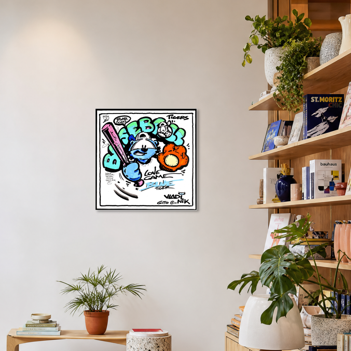Gito Fine Art Print - Art Vladi Vl Comics - Tigers
A framed cartoon art print featuring colorful graffiti-style characters and text, displayed on a light beige wall in a styled room with shelves, books, and potted plants.