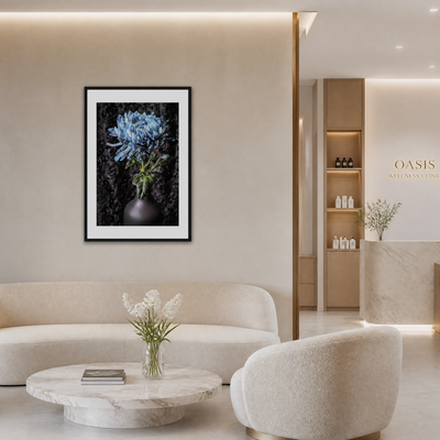 Modern living room with a framed floral artwork on the wall, a white sofa, and a marble coffee table. Blue Chrysanthemum ~ Fine Art Photography by Ivo Titzin ~ Limited Edittion Wall Decor by Gito Art