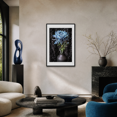 Living room with a framed artwork of flowers, blue sculpture, and decorative items. Blue Chrysanthemum ~ Fine Art Photography by Ivo Titzin ~ Limited Edittion Wall Decor by Gito Art