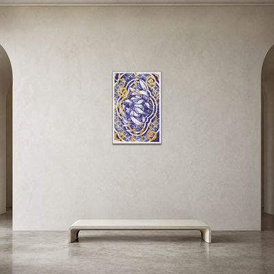 A framed vertical art print with a blue and gold floral mandala design hangs on a textured beige wall above a minimalist white bench in a modern interior setting.