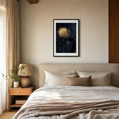 Neatly made bed in a bedroom with a framed artwork on the wall. ~ Pincushion Protea ~ Fine Art Photography by Ivo Titzin ~ Luxury Wall Art by Gito ~ Limited edition