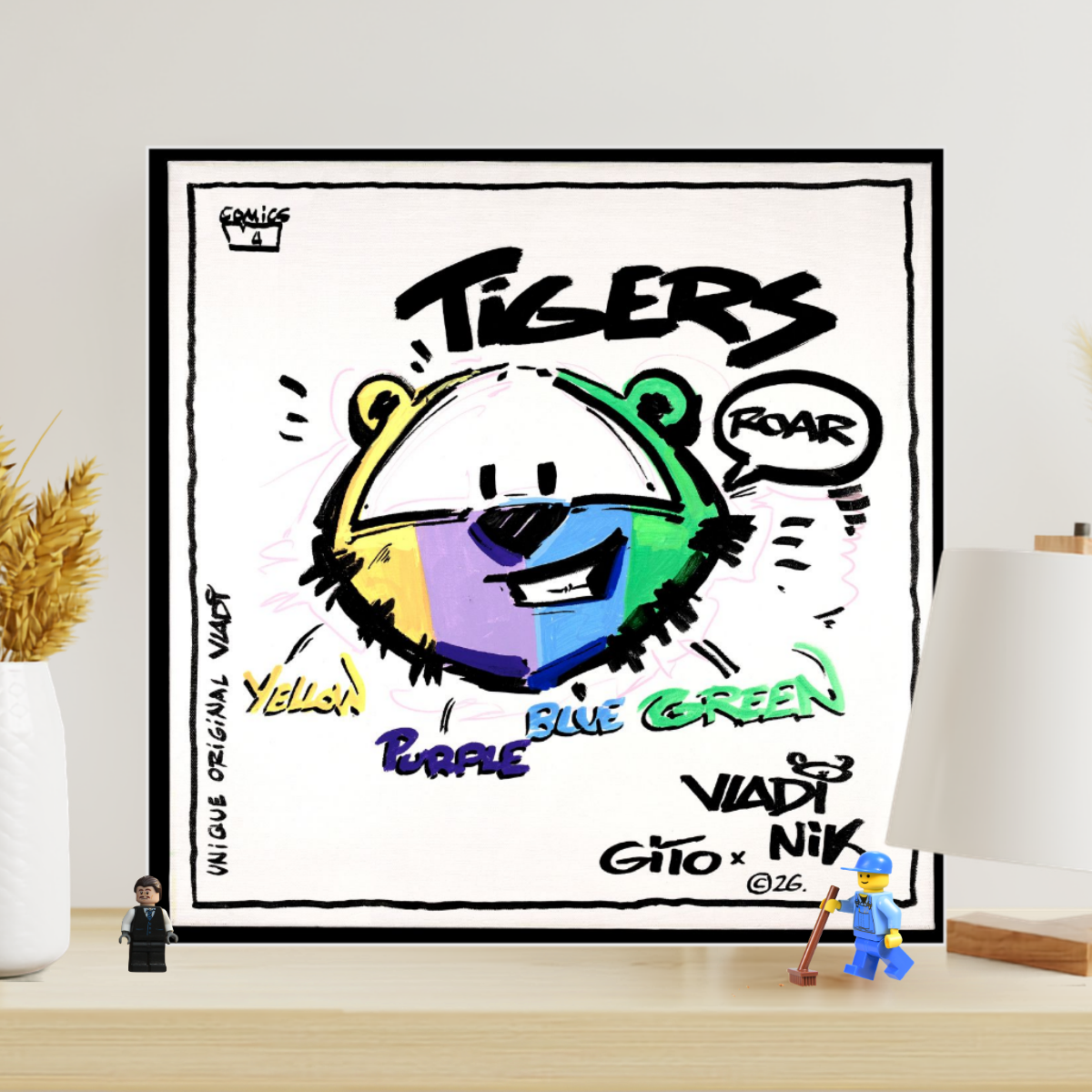 Gito Fine Art Print - Art Vladi Vl Comics - Tigers
A framed custom art print featuring a colorful tiger illustration with graffiti-style text, displayed on a wooden shelf in a styled room setting with a lamp, vase, and small figurines.