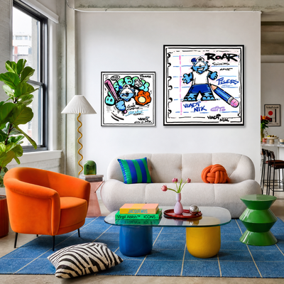 Gito Fine Art Print - Art Vladi Vl Comics - Tigers
A styled living room interior with two framed pop-art prints hanging above a white sofa. The prints feature illustrated cartoon characters with bold text including 'ROAR'
