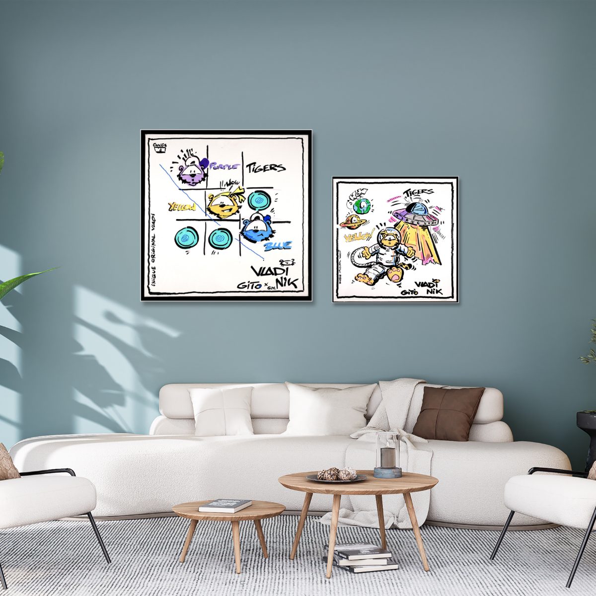 Gito Fine Art Print - Art Vladi Vl Comics - Tigers
Two framed art prints featuring colorful cartoon characters and graffiti-style lettering, displayed on a blue-gray wall above a modern white sofa in a styled living room.