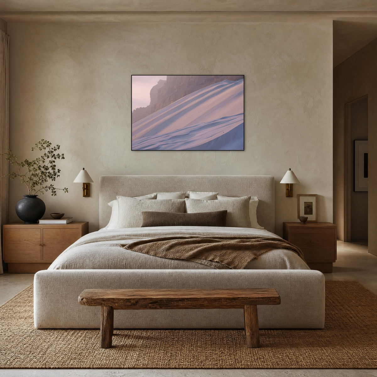 Gito.Art - Exclusive Art Print - Photography by Delyan Markov
A modern bedroom featuring a large framed abstract landscape art print with pink, purple, and blue tones, hung symmetrically above a neutral beige bed with a rustic wooden bench at the foot.