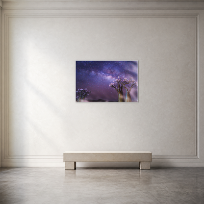 Gito.Art - Exclusive Art Print - Photography by Delyan Markov
A framed wall art print depicting a purple and blue night sky with two flowering trees, displayed on a light beige wall above a minimalist bench in a modern room setting.