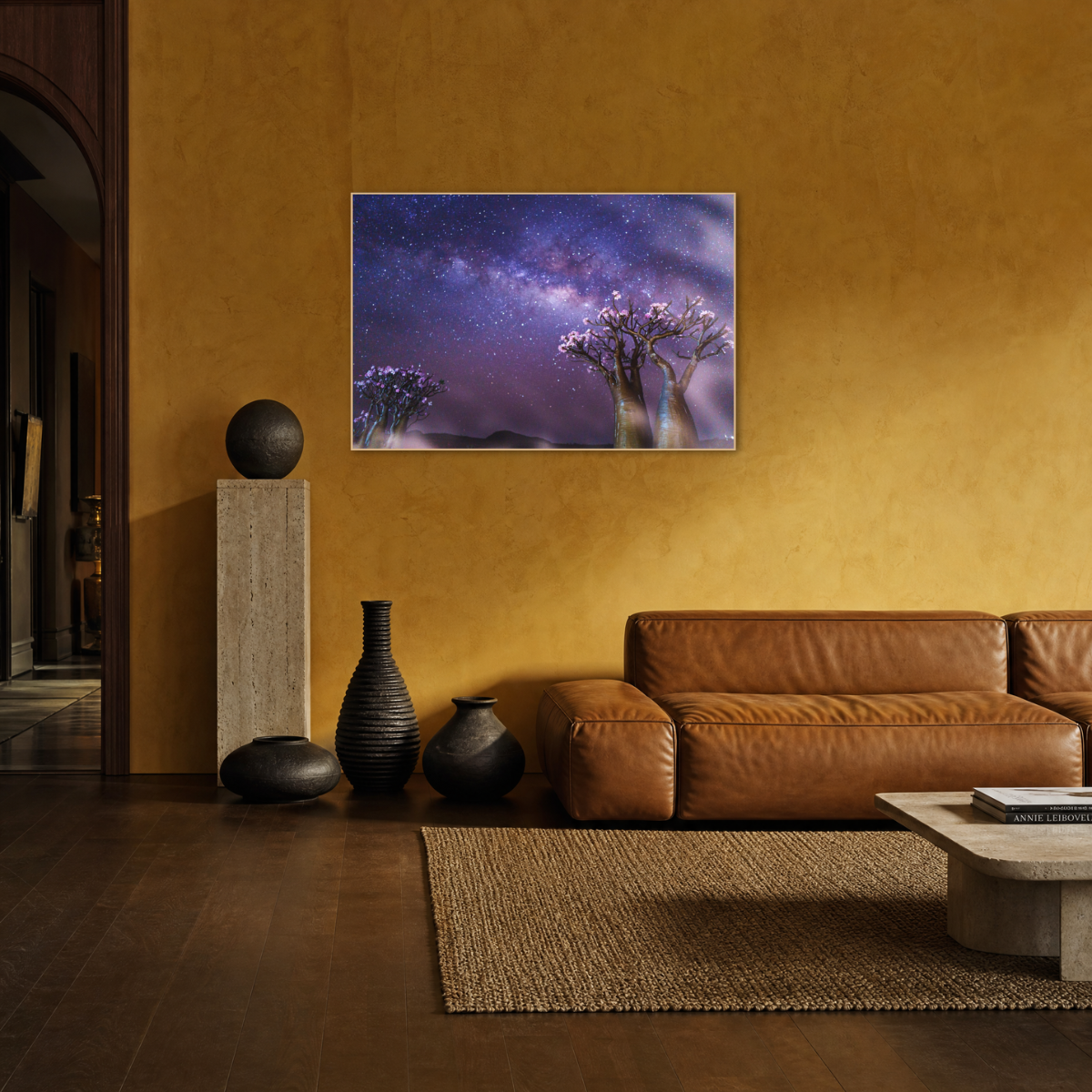 Gito.Art - Exclusive Art Print - Photography by Delyan Markov
A framed wall art print depicting a starry purple and blue night sky with glowing trees, displayed above a brown leather sofa in a warm, modern living room with a mustard yellow wall.