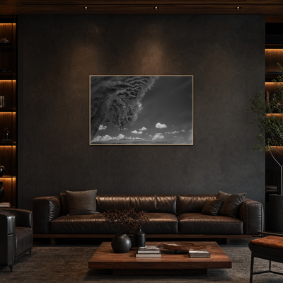 Gito.Art - Exclusive Art Print - Photography by Delyan Markov
A black and white dramatic storm cloud wall art print with a thin gold frame, displayed on a dark textured wall above a brown leather sofa in a modern living room setting.