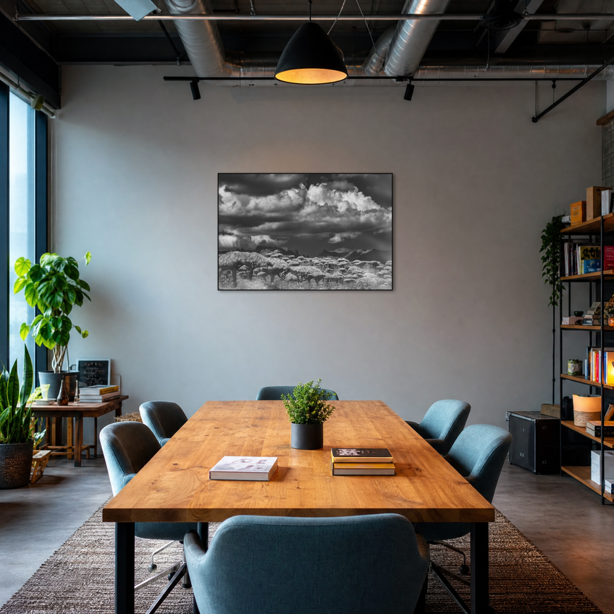 Gito.Art - Exclusive Art Print - Photography by Delyan Markov
A black and white landscape art print depicting snowy mountains under a cloudy sky, displayed on a gray wall in a modern office setting with a wooden conference table and blue chairs.