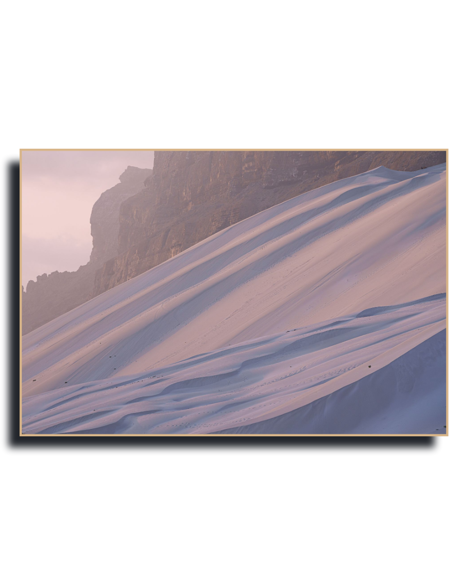 Gito.Art - Exclusive Art Print - Photography by Delyan Markov
Gito.Art - Exclusive Art Print - Photography by Delyan Markov
A framed landscape art print depicting a snowy mountain slope under a soft pinkish sky, with a dark rocky cliff on the left. The print is shown with a subtle drop shadow on a plain white background.