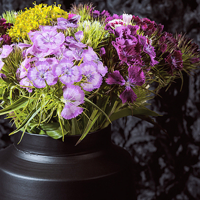 Bouquet of purple, yellow, and green flowers in a black vase against a dark background  ~ Fine Art Photography by Ivo Titzin ~ Gito Limited Wall Art 