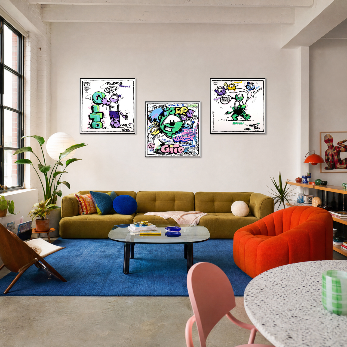 Gito Fine Art Print - Art Vladi Vl Comics - Tigers
Three framed graffiti art prints featuring cartoon characters are displayed on a white wall above a mustard yellow sofa in a modern, brightly lit living room.