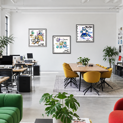 Gito Fine Art Print - Art Vladi Vl Comics - Tigers
A bright, modern office interior with three framed art prints hanging on a white wall above a wooden conference table and yellow chairs. The room includes desks, computers, potted plants, and colorful furniture in the foreground.